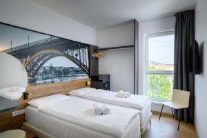Postel nebo postele na pokoji v ubytování B&B Hotel Maribor