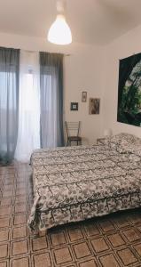 a bedroom with a bed and a window at Nicolai63 in Bari
