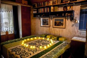 a bedroom with a bed with lights on it at Train_house_ns in Petrovaradin