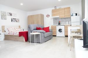a living room with a couch and a table at APARTAMENTOS TURÍSTICOS SAN MIGUEL ARCÁNGEL, S.L. in San Roque