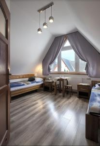 een kamer met 2 bedden en een groot raam bij Willa Pod Wierchem in Bukowina Tatrzańska
