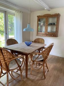 a dining room table with chairs and a blue bowl on it at Bondehus - Dansk bondehus med patina in Sindal