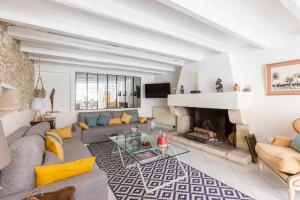 a living room with a couch and a fireplace at Le Chai de La Boirie in Saint-Pierre-dʼOléron