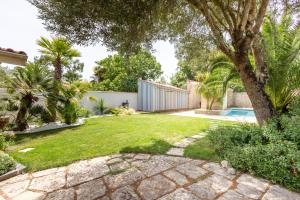 a garden with a swimming pool and a house at Le Chai de La Boirie in Saint-Pierre-dʼOléron