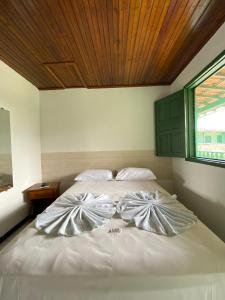 En eller flere senge i et værelse på Pousada Tapuia