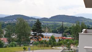 a view of a city with mountains in the background at Pokoje Gościnne Zielony Zakątek in Jelenia Góra