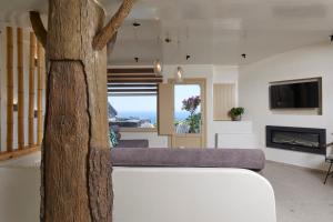 a living room with a couch and a fireplace at Endless Traditional Houses in Fira