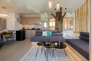 a living room with a couch and a table at Endless Traditional Houses in Fira