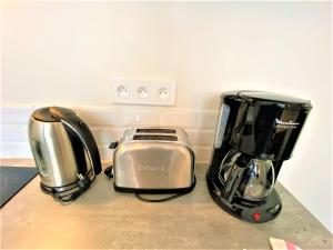 two toasters and a toaster on a counter at Appartements Rue Sarret XXL in Angers