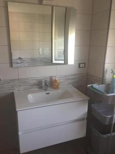 a bathroom with a white sink and a mirror at Appartamento dei nonni di Gio e Cry in Sperlonga +13 photos