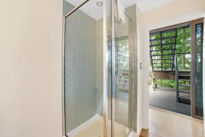 a glass shower in a bathroom with a glass door at Avant Garde Seneca in Dundee