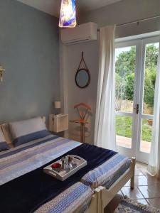 a bedroom with a bed with a tray of food on it at Casa Guido in Cittadella del Capo