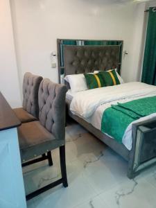 a bed and a chair in a room at Muka homes in Naivasha +10 photos