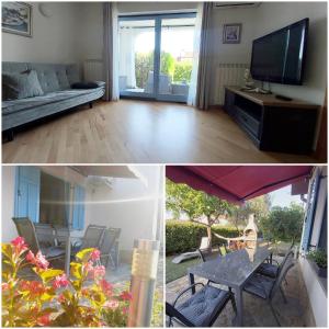 a living room with a couch and a tv and a table at SALT & SAGE Apartment in Manzano