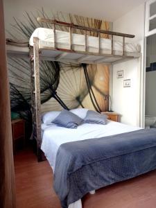 a bedroom with two bunk beds in a room at La terrasse Majorelle. in Le Passage