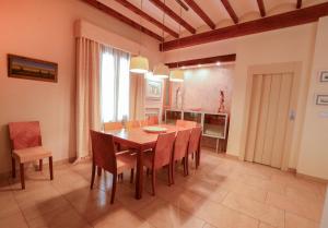 a dining room with a wooden table and chairs at Casa Paquita in Calpe