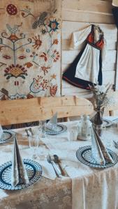 a table with plates and utensils on top at Karczma Kubalonka in Istebna