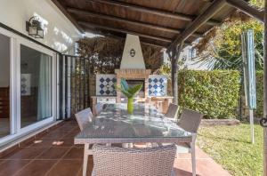a dining table and chairs on a patio at OleHolidays Balcones de Bellavista in Estepona