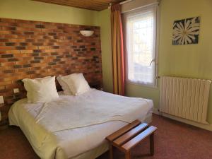 Postel nebo postele na pokoji v ubytování L'AUBERGE DE L'OLIVE