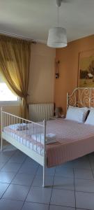 a bedroom with a white bed with a canopy at House Kallisti in Sikia +24 photos