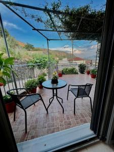 a patio with a table and two chairs on a patio at house in the village 