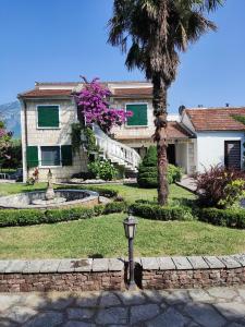 a house with a palm tree and a street light at Leisure House Jovovic in Bar