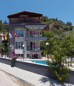 a building with a pool in front of it at Hanlı Apart Otel in Muğla