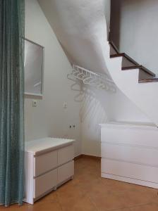 a room with white walls and a staircase with at Horizon Studios with Sea View - Free Parking in Glossa