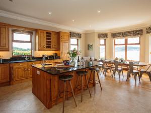 a large kitchen with a table and a dining room at Kringlands in Stranraer