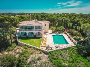 an aerial view of a house with a swimming pool at Villa Can Pere Cala Galdana Menorca in Cala Galdana