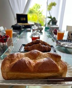 two loaves of bread sitting on a glass table at ENTRE TERRE ET MER in Blonville-sur-Mer