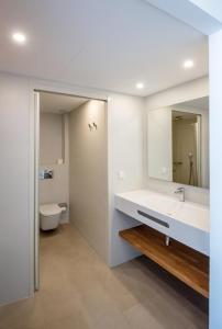 La salle de bains est pourvue d'un lavabo, de toilettes et d'un miroir. dans l'établissement Apartamentos Es Pujols - Emar Hotels, à Es Pujols