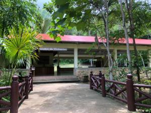 a building with a fence in front of it at Parque Natural Ixpanpajul in Santa Elena