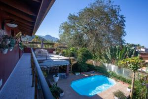 an outdoor patio with a swimming pool and a table at Ubatuba Ecologic Pousada in Ubatuba