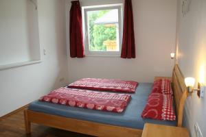 a bed with two pillows on it in a room at Ferienwohnung Jäger in Strassen