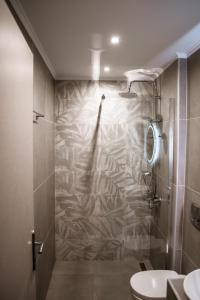 a bathroom with a shower and a toilet at To Petrino (VIlla Markos) in Parga