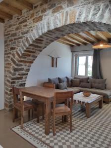 a living room with a couch and a table at Traditional suites in Chora Kythnos #6 in Kithnos