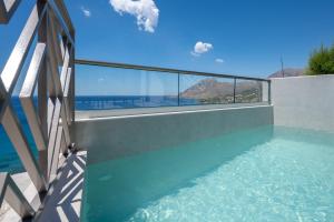 a swimming pool with a view of the ocean from a house at Sunset View in Plakias