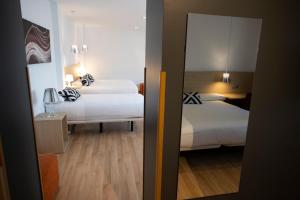 Postel nebo postele na pokoji v ubytování Hotel Restaurante Cadosa