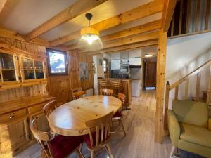 a kitchen and dining room with a wooden table and chairs at Chalet Barcelonnette, 4 pièces, 8 personnes - FR-1-165A-121 in Barcelonnette