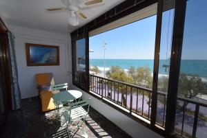 a room with a balcony with a view of the ocean at BENIBEACH - Fincas Arena in Benidorm