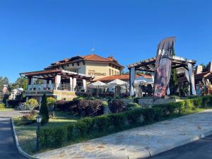 a building with a restaurant with a giant chair at Family Hotel Eterno in Tsigov Chark