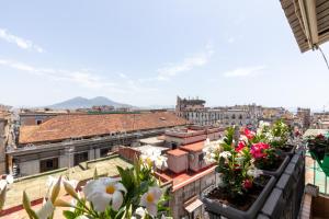 a view of a city with flowers on the roofs at Salotto Napoletano 381 in Naples