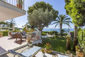 a house with a patio with a view of the ocean at Bell Punt in Alcudia