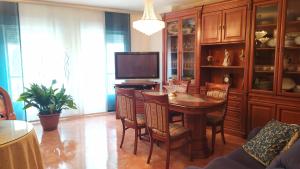 a dining room with a table and a television at El Santo in Torres