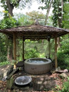 a gazebo with a hot tub in the woods at mon Ecolodge Creole in Fort-de-France