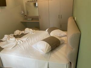a large white bed with pillows in a room at Marko's Cozy Apartment in Megalochori