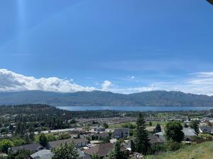 a view of a town with a lake and mountains at Shannon Heights B&B in West Kelowna