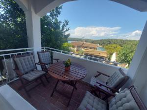 a patio with a table and chairs on a balcony at Apartment Iva Pula in Banjole