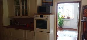 a kitchen with a microwave on top of an oven at ZALASEK Gospodarstwo Agroturystyczne z Alpakami in Dobra